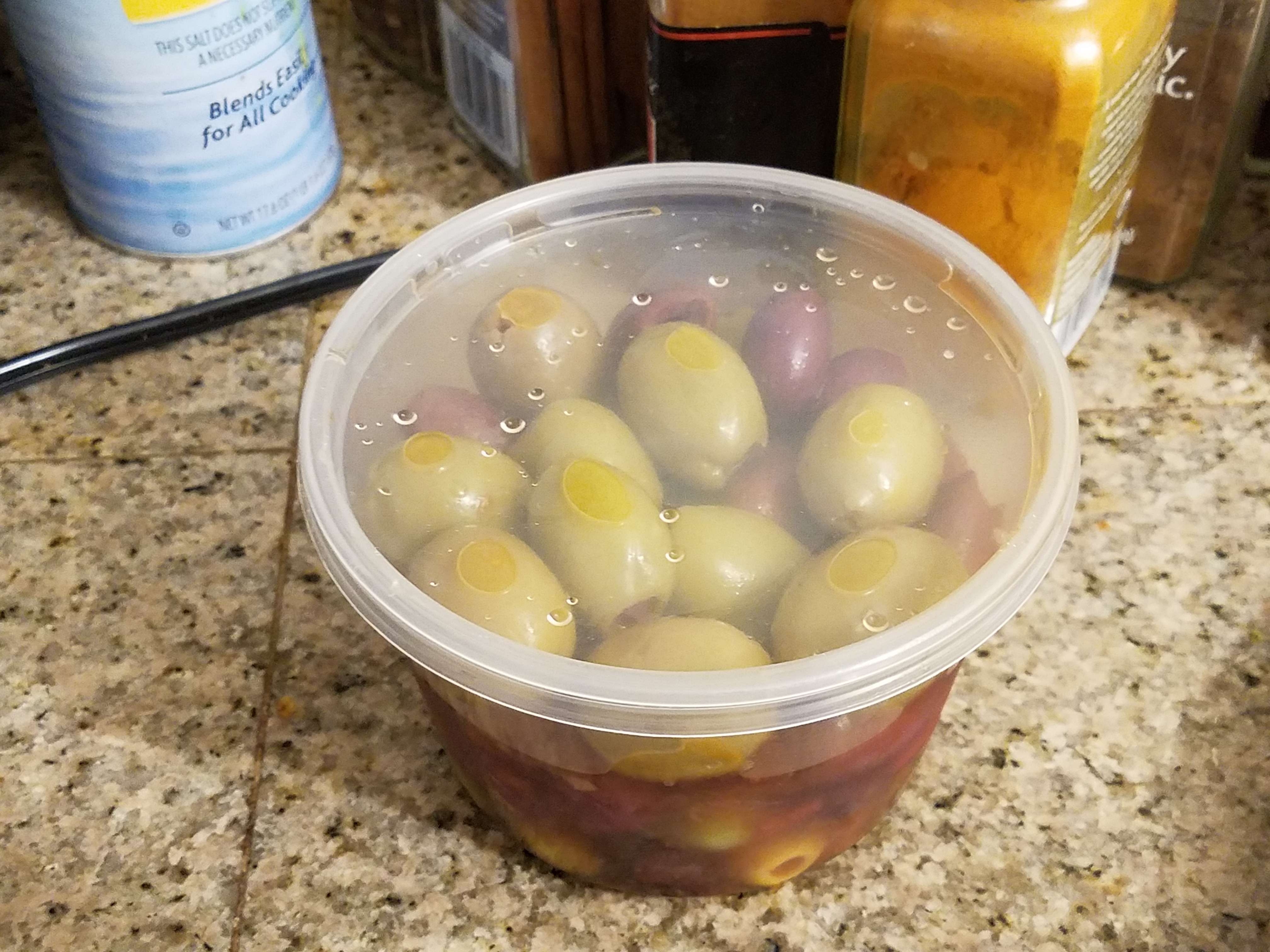 Living well in the 21st century. Limassol, Cyprus. A plastic container with olives and olive oil. 
