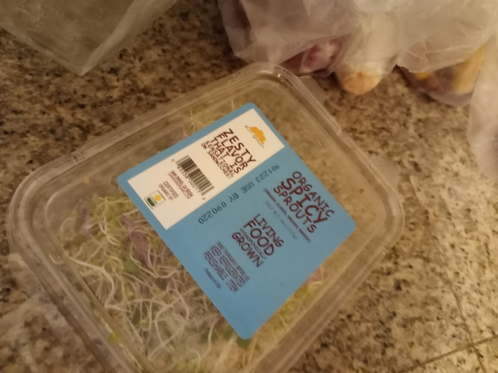 Living well in the 21st century - Limassol, Cyprus - blue, white label that says; zesty flavor that is sensational, use by 090220 - organic spicy sprouts - living food. 