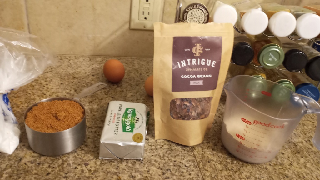 Living well in the 21st century - Limassol, Cyprus - a picture with two eggs, 1 cup coconut sugar, kerrygold pure irish butter, intrigue cocoa beans package, 3/4 cup tiger nut flour, and baking powder. 