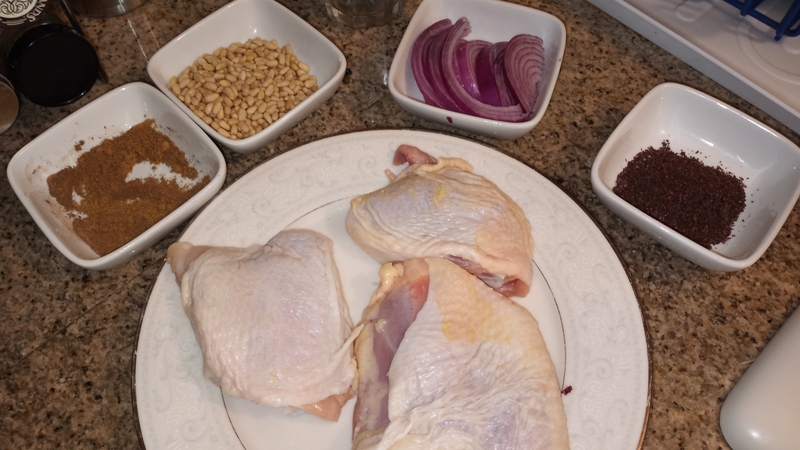 Living well in the 21st century. Limassol, Cyprus. Mise en place: 4 raw chickens placed on a plate, sliced red onion in a small plate, pine nuts in a small plate, sumac and cumin in small plates. 