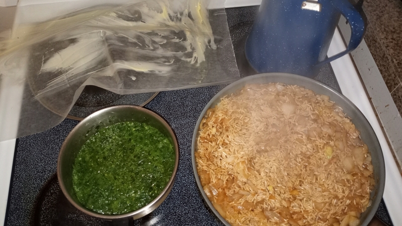 Living well in the 21st century. Limassol, Cyprus. Parchment paper with butter, a small pot with green sauce, and large saucepan with rice cooking. 