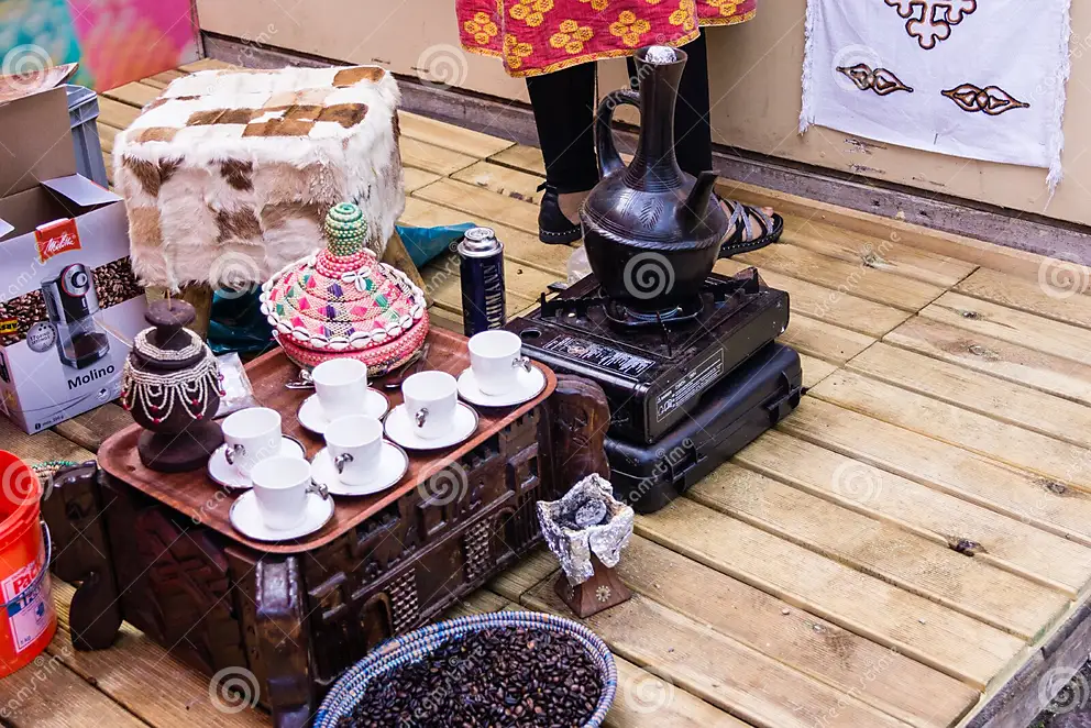 Living well in the 21st century-Limassol, Cyprus. A picture of a traditional coffee ceremony with cups, and a vase on a table, and decorations. 